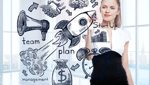 A woman in a business suit holds a drawing of a rocket alongside various business ideas, showcasing her creative vision.